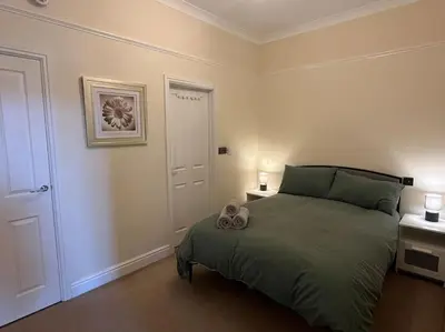 a bedroom with a bed with two stuffed animals on it at Thurnams House, Ground Floor Apt in Carlisle