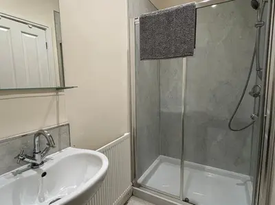 a bathroom with a shower and a sink and a shower at Thurnams House, Ground Floor Apt in Carlisle