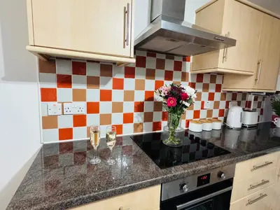 a kitchen with a vase of flowers on a counter at Curwen Apartment - 2 Bedrooms - Sleeps 6 in Workington