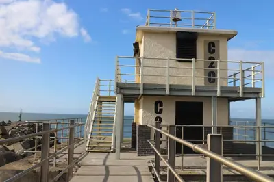a light house on the beach with a staircase at Curwen Apartment - 2 Bedrooms - Sleeps 6 in Workington