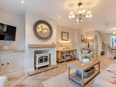 a living room with a fireplace and a tv at 2 Bed in Cockermouth 94787 in Broughton Moor