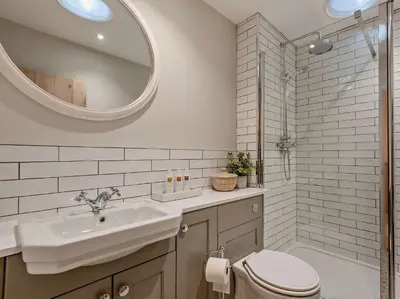 a bathroom with a sink and a toilet and a mirror at 2 Bed in Cockermouth 94787 in Broughton Moor
