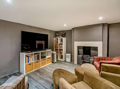 a living room with a tv and a couch and chairs at 3 Bed in Cockermouth oc-94928 in Cockermouth