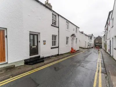 an empty street with white buildings on the side at Darwin Cottage in Keswick