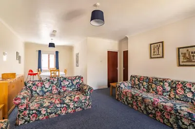a living room with a couch and a table at Lakeland Nook in Keswick