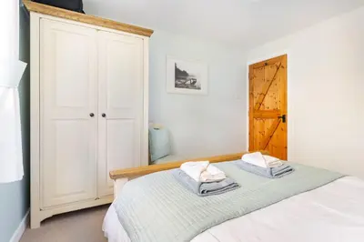 a bedroom with a bed with two towels on it at The Mews in Keswick