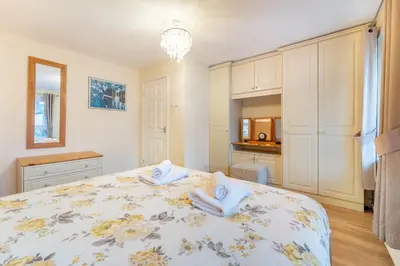 a bedroom with a bed with towels on it at Sunny Cottage in Keswick