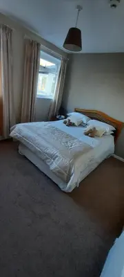 a large bed in a bedroom with a window at The White Heather Hotel in Wigton