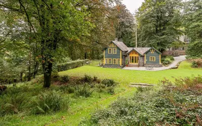 a blue house in the middle of a yard at Carr Crag Pavilion in Little Langdale