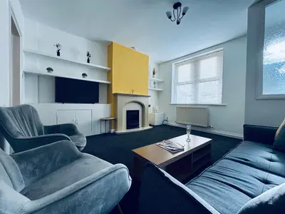 a living room with two chairs and a couch and a table at Cumberland House-2 Bedrooms - Sleeps 4 in Workington