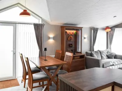 a living room with a table and a couch at Solway Escape in Plumbland