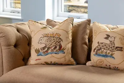 two pillows sitting on top of a couch at The Gardeners Cottage, Hutton John is a luxurious cottage with hot tub 10 minutes from Lake Ullswater in Penruddock