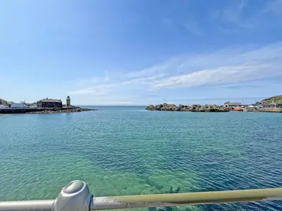 a view of the ocean from the bow of a boat at Driftwood Cottage in Portpatrick