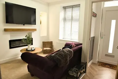a living room with a couch and a tv at Quirky & Comfortable Residence in Workington