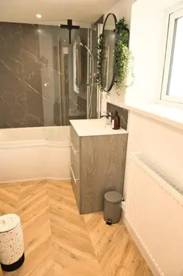 a bathroom with a sink and a shower at Quirky & Comfortable Residence in Workington