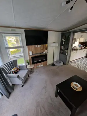 a living room with a couch and a table at The Forest Cabin Holiday Home 15 in Ballantrae