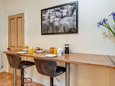 a dining room table with chairs and a tv on the wall at 2 Bed in Keswick oc-94995 in Keswick