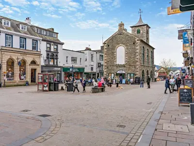 a street in a town with people walking around at 2 Bed in Keswick oc-94995 in Keswick