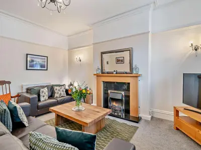a living room with a couch and a fireplace at 2 Bed in Keswick oc-94995 in Keswick