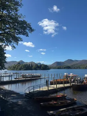 a group of boats docked at a dock on a lake at Shemara rooms in Keswick