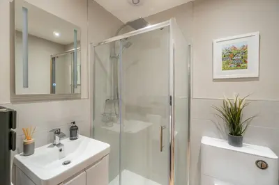 a bathroom with a shower and a sink at Gingerbread Nook in Grasmere