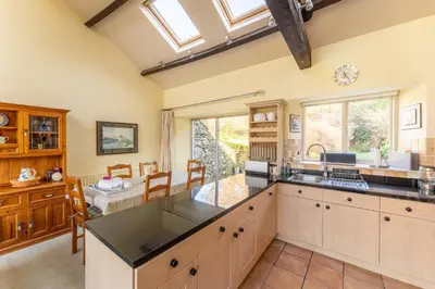 a kitchen with a large island and a dining room at Grey Crag Barn in Grasmere