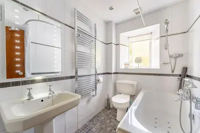 a white bathroom with a sink and a toilet at Grey Crag Barn in Grasmere