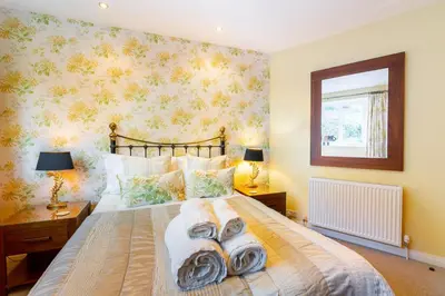 a bedroom with a bed with towels on it at Grey Crag Barn in Grasmere