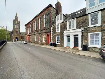 an empty street in a town with a clock tower at Beautiful House With Stunning Views Kirkcudbright - Pass the Keys in Kirkcudbright
