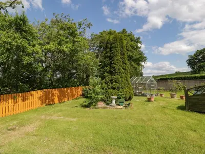 a garden with a fence and a tree at Largieholm in Mauchline