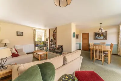 a living room with a couch and a table at Le Tholonet in Grasmere