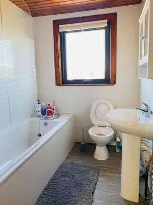 a bathroom with a tub and a toilet and a sink at Golfers lovers! Near all famous golf courses in Prestwick