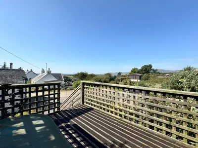 a bench sitting on top of a wooden bridge at Birds Nest in Gatehouse of Fleet