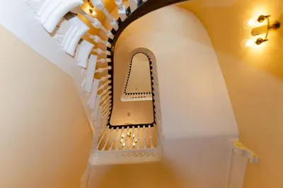 a staircase in a house with a spiral stair case at Opul Boutique at Admiral House in Douglas