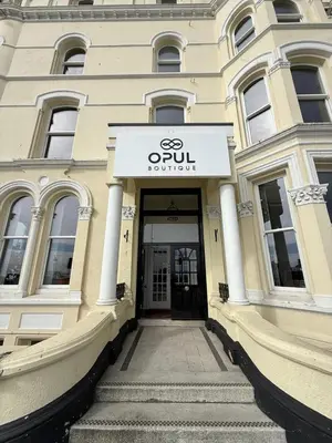 a building with a sign on the front of it at Opul Boutique at Admiral House in Douglas