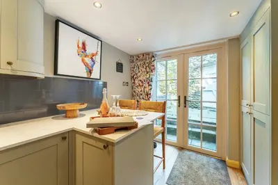a kitchen with a counter and a table at Poet's Corner in Grasmere