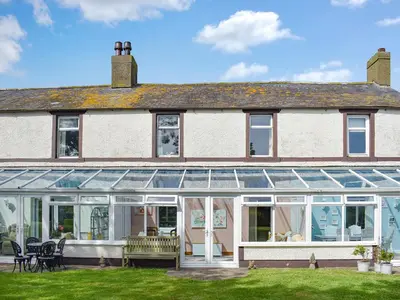 an extension to a house with a conservatory at The Stables in Beckfoot