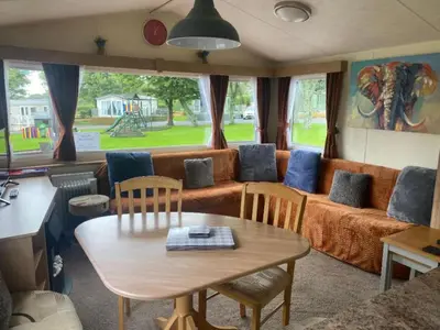 a living room with a couch and a table at 23 The Beeches in Gilcrux
