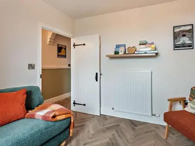a living room with a couch and a door at 2 Bed in Arlecdon 95126 in Arlecdon