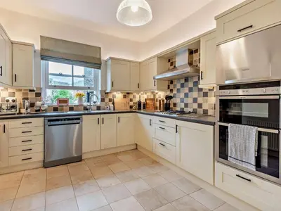 a kitchen with white cabinets and stainless steel appliances at 3 Bed in Keswick oc-95032 in Keswick