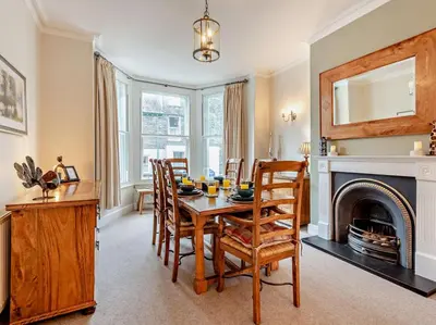 a dining room with a table and chairs and a fireplace at 3 Bed in Keswick oc-95032 in Keswick