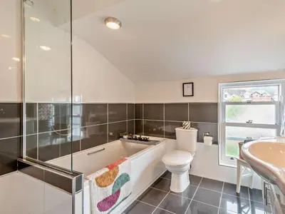 a bathroom with a tub and a toilet and a sink at 3 Bed in Keswick oc-95032 in Keswick