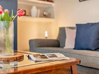 a living room with a coffee table with a vase of flowers at 3 Bed in Keswick oc-95032 in Keswick