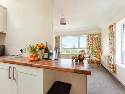 a kitchen with a counter with oranges on it at Carraig Dhubh Cottage - Uk47123 in Whiting Bay