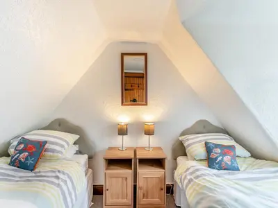 two twin beds in a attic room with a mirror at Carraig-Dhubh South - Uk47124 in Whiting Bay