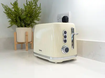 a toaster sitting on a counter next to a plant at The Penthouse - Crosby St 2 Bed in Maryport