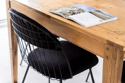 a wooden table with a black chair in front of a book at Oakbank-Central Grasmere in Grasmere