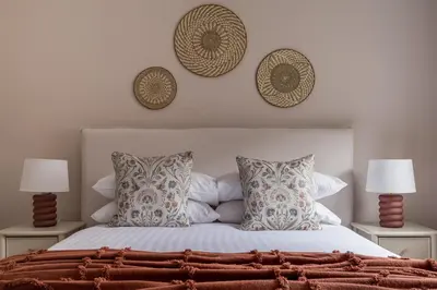 a bedroom with a bed with pillows and two lamps at Oakbank-Central Grasmere in Grasmere