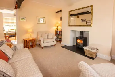 a living room with a couch and a fireplace at Myrtle Cottage in Chapel Stile