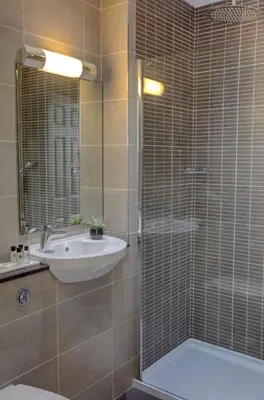 a bathroom with a sink and a toilet and a shower at Crown & Mitre Hotel in Carlisle